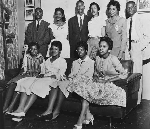 A photograph of activist Daisy Bates (back row, 2nd from right) surrounded by the "Little Rock Nine" group of students that she helped integrate into the previously all-white Little Rock Central High School in 1957.  This looks to be like a photograph taken after they graduated high school.