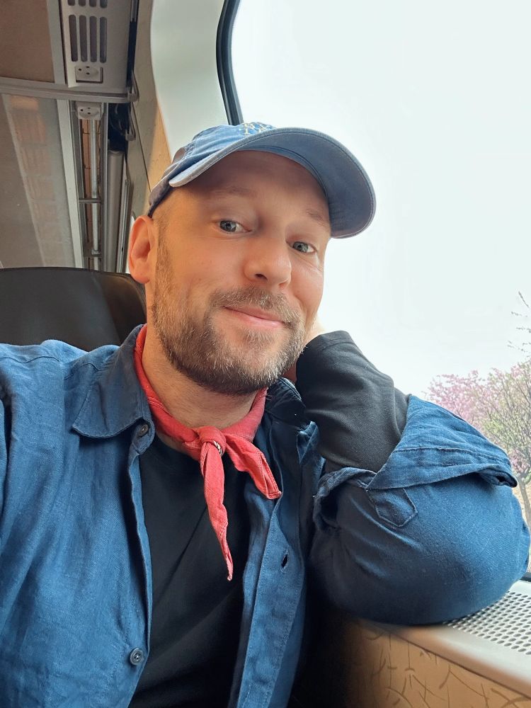 Selfie of a happy traveller on a train