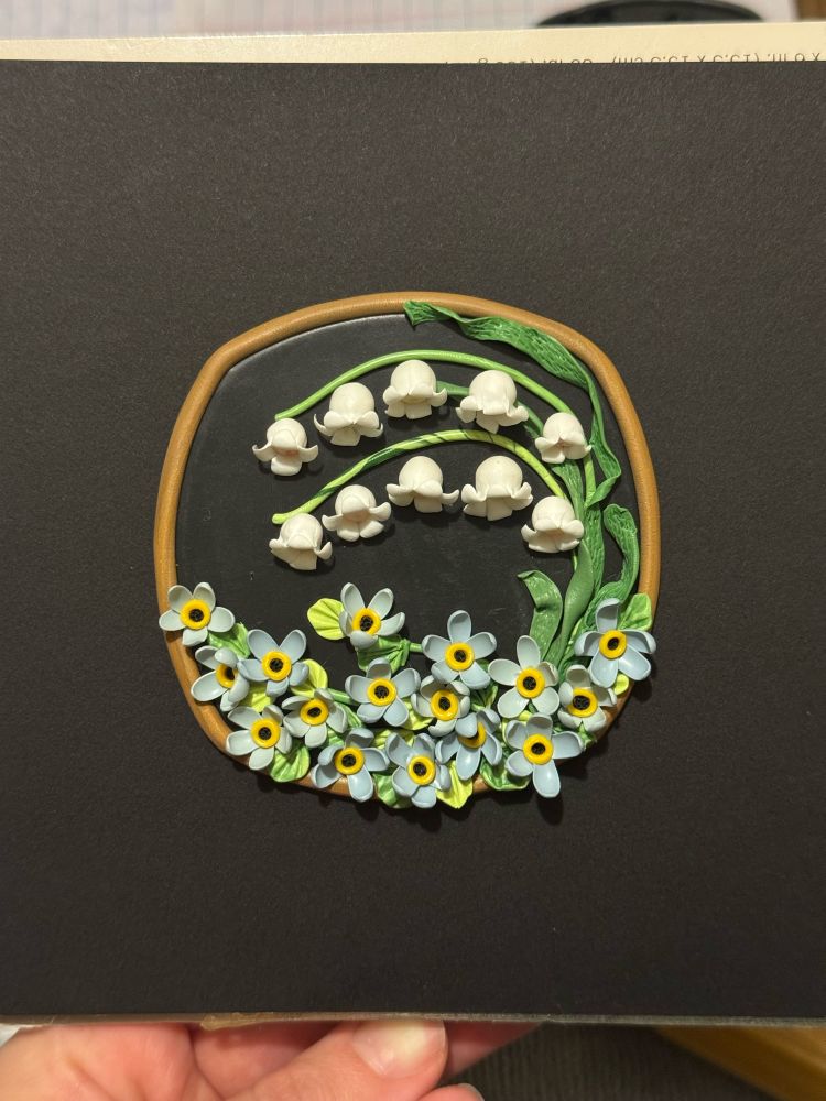 White Lily of the valley, blue forget me nots, black background, polymer clay. 