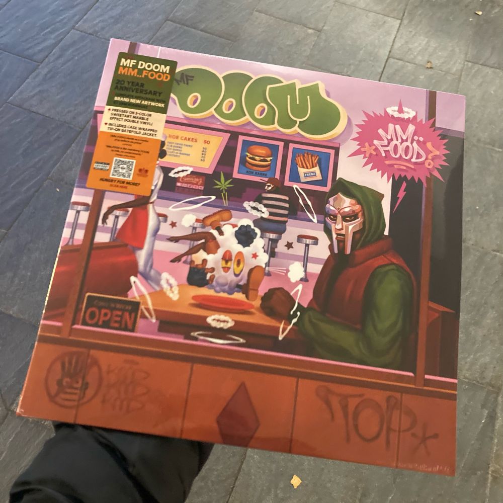 Holding a vinyl copy of “MM..Food 20th Birthday Edition” 