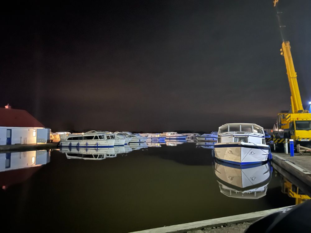 Boats at night at the Herbert Woods boatyard in Potter Heigham