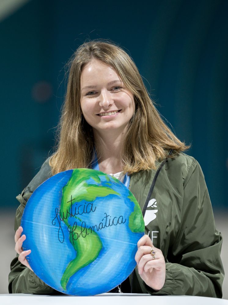Baku, Azerbaijan: Carine Wendland of the Evangelical Church of the Lutheran Confession in Brazil pictured with the image of a globe on which she has written 'Justicia Climática' ('Climate Justice'), at the United Nations climate summit COP29