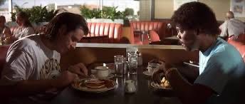 Scene from Pulp Fiction with Jules and Vincent eating in a diner. Jules is saying "Sewer rat might taste like pumpkin pie, but I'll never know 'cause I wouldn't eat the filthy motherfucker."