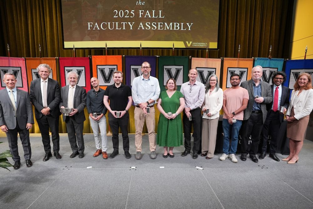 Photo of all the awardees with Vanderbilt leadership. Lisa's in a green dress and holding a silver cup