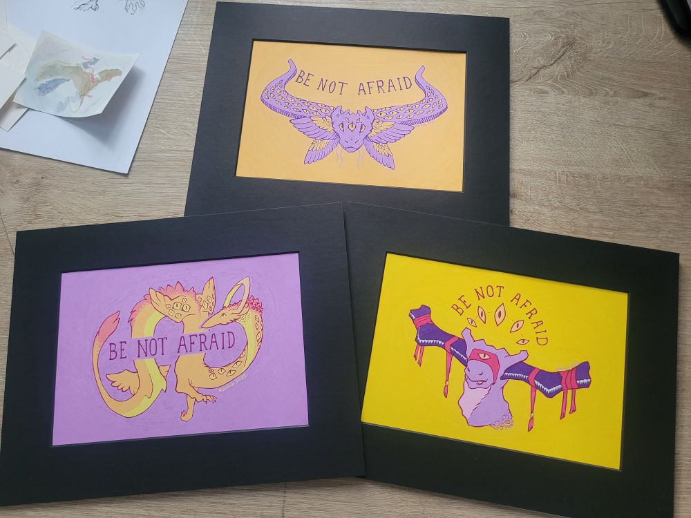 The previous three art pieces placed on a table together, ready to be exhibited.