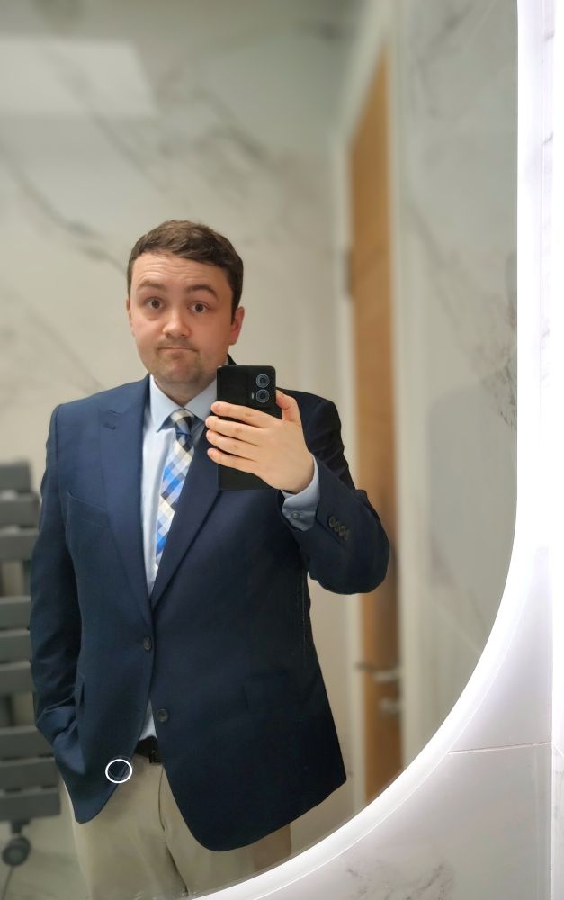 Mirror selfie of me in a blue suit jacket & blue tie