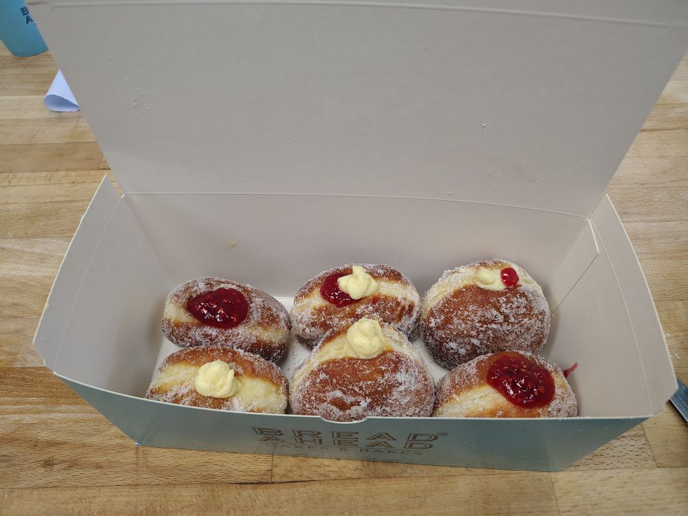 Six filled doughnuts piped with jam and Chantilly cream