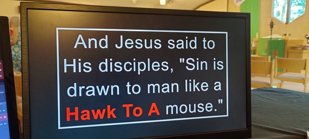 A computer screen with a church presentation up that reads "and Jesus said to His disciples, 'Sin is drawn to man like a Hawk To A mouse.'" The words "Hawk To A" are bold and in red.