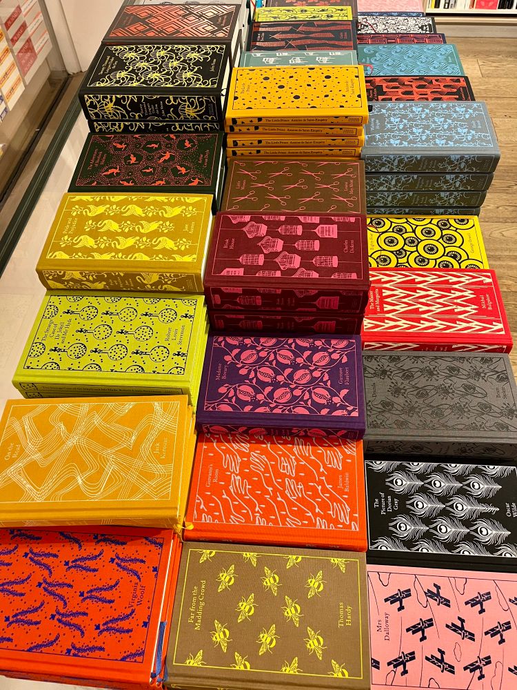 Table with many beautiful, colorful classic books. 