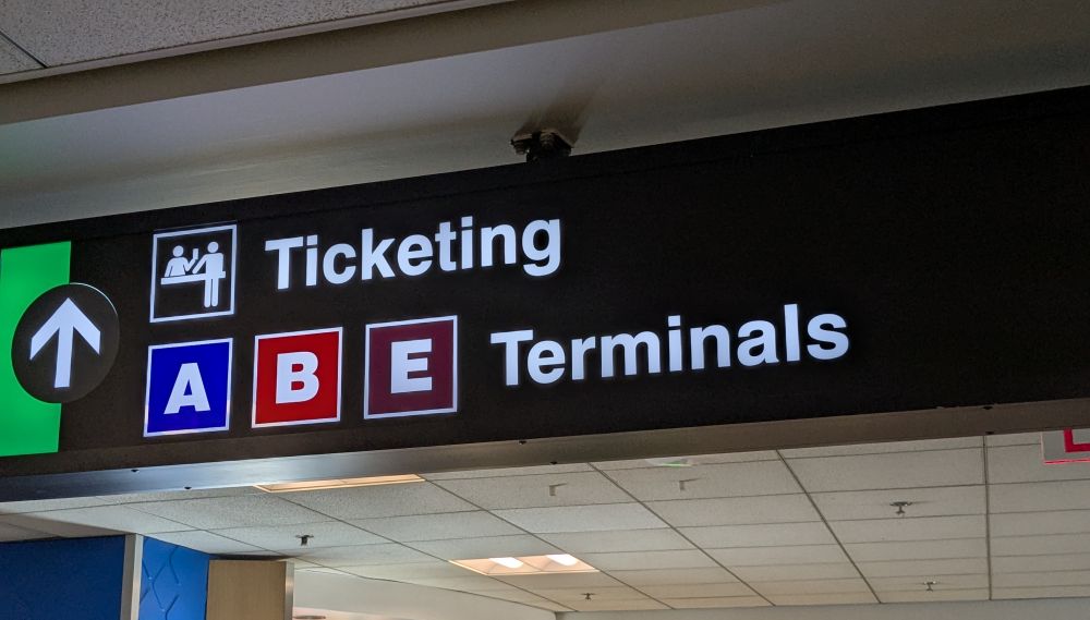 Photo of a sign at an airport with directions to ABE Terminals