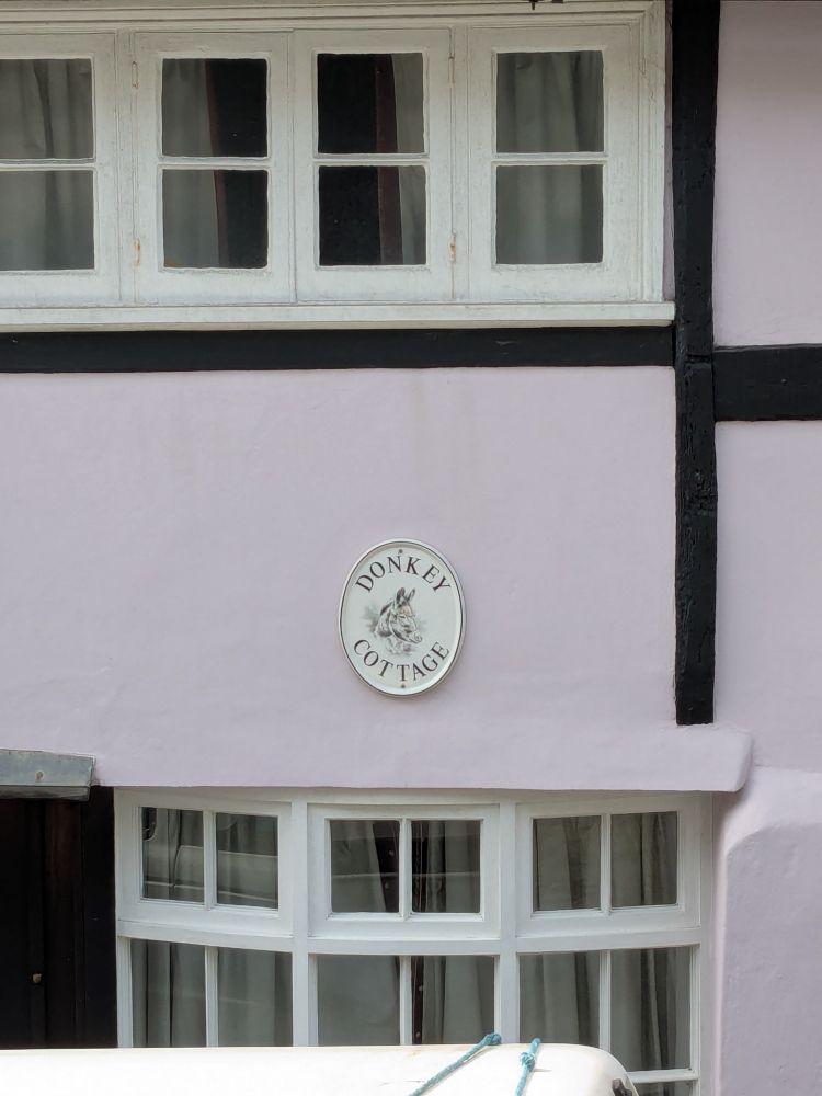 A building with a sign reading "Donkey Cottage"