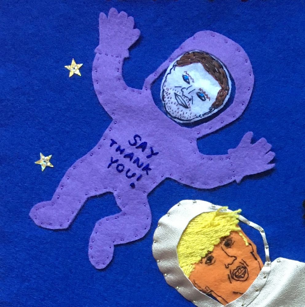 JD Vance floating in a lilac space suit with the words “Say thank you!” written on it. Trump (partial view) in the foreground in a gold space suit. 