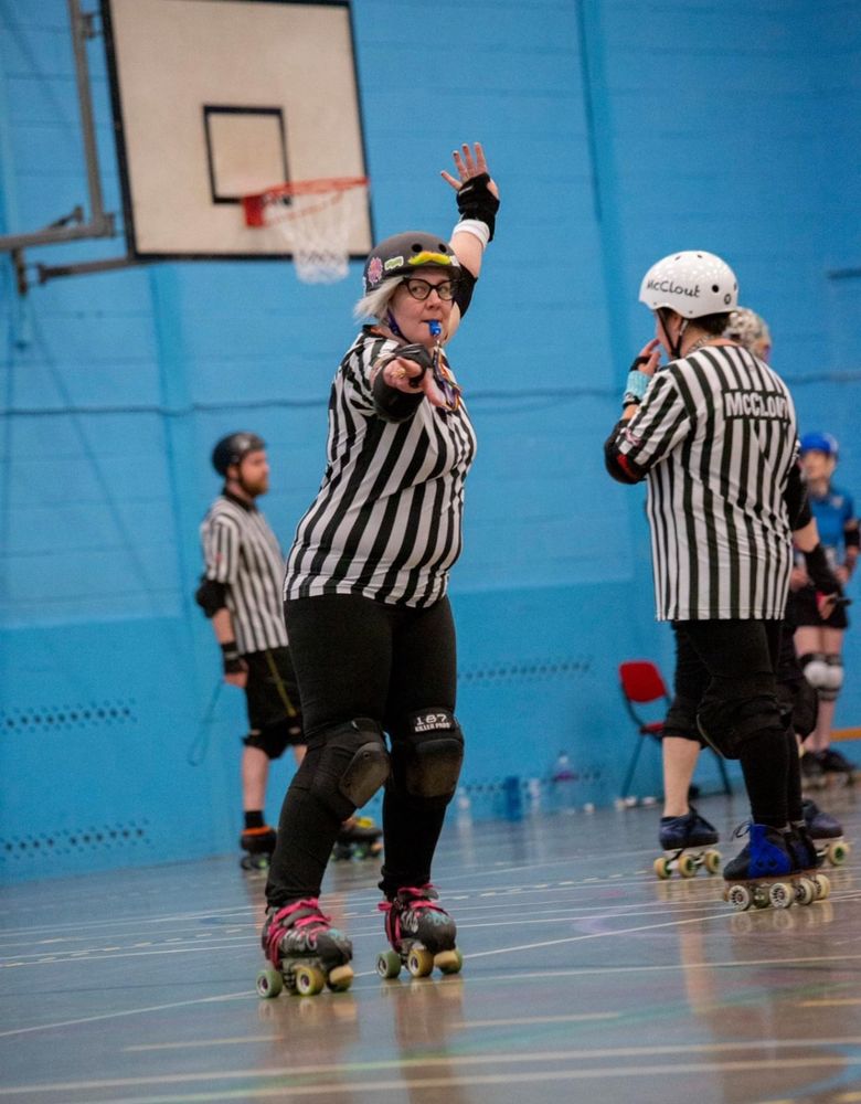 A picture of me reffing, my top is figure hugging