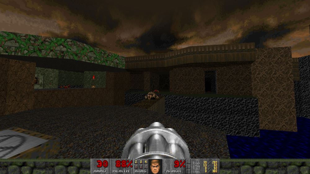 In Doom with the protagonist carrying a chaingun. There is a small bridge leading to a platform. There are multiple enemies defeated on the floors. The sky is brown.