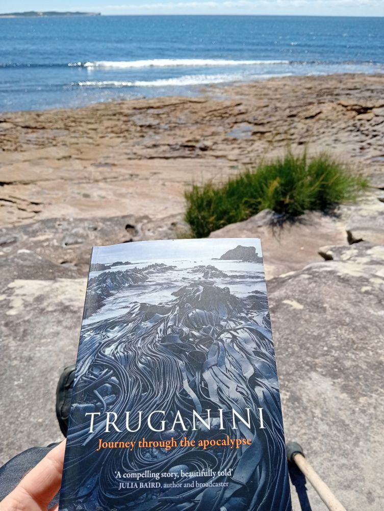 A pic of the book Truganini by Cassandra Pybus. The background is sandstone in the foreground and the sea to the horizon. 