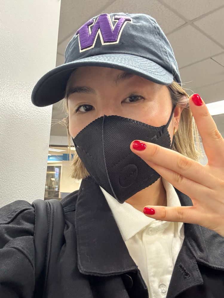 Rin wearing a University of Washington hat at the airport