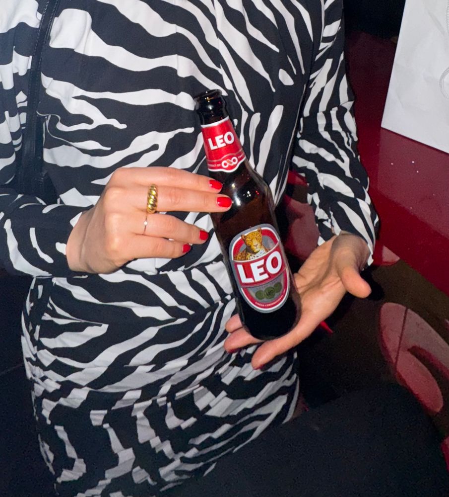 Rin displaying a bottle of Leo beer