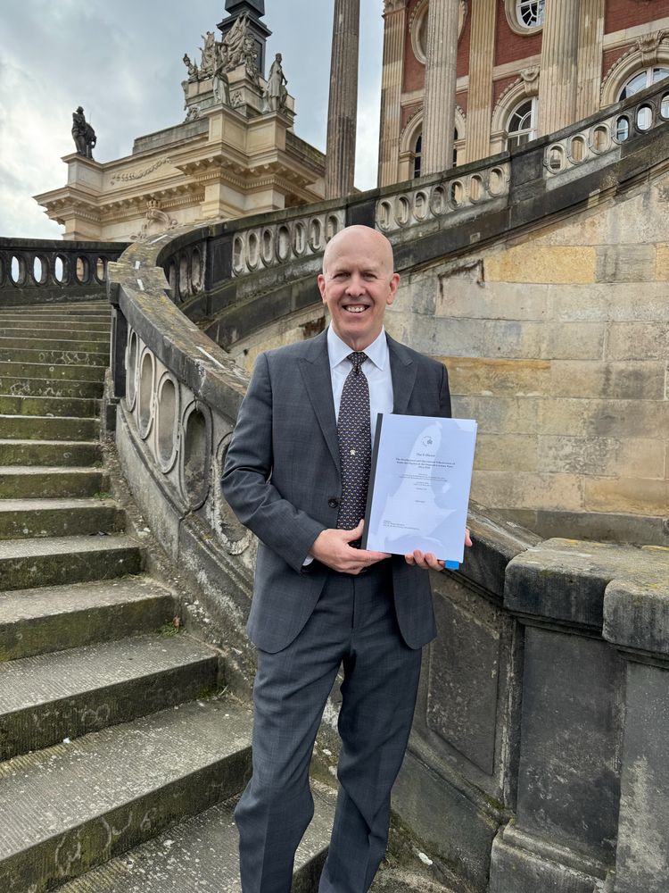 Standing on the steps of Universität Potsdam