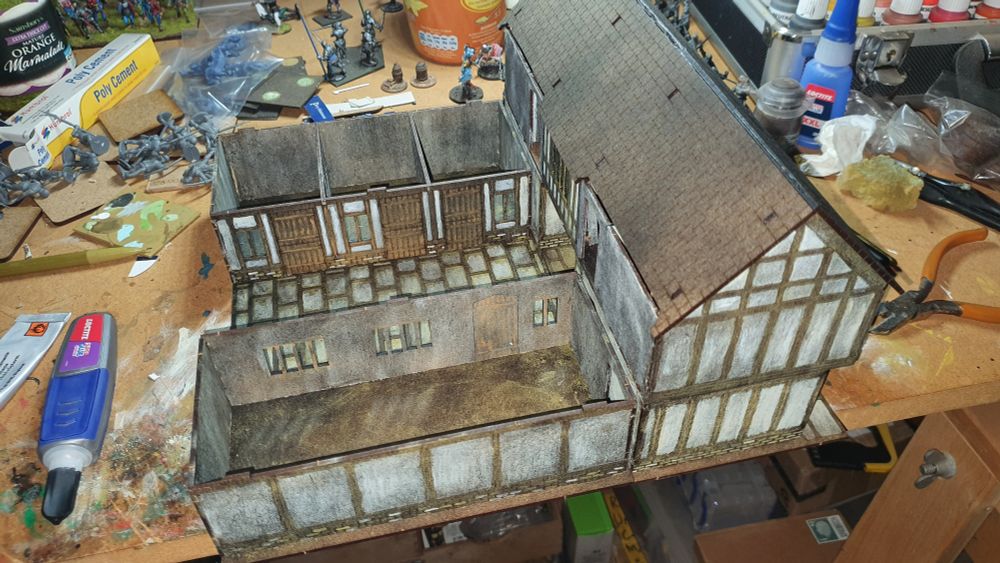 Part built and painted model Tavern on a painting table.