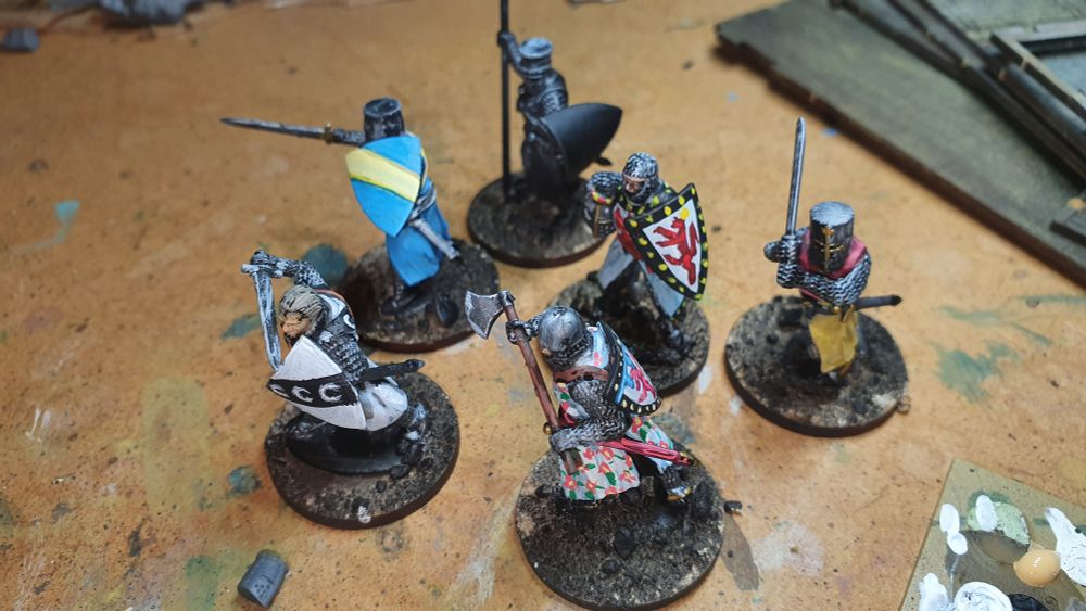 Six 26mm knights, mostly painted.