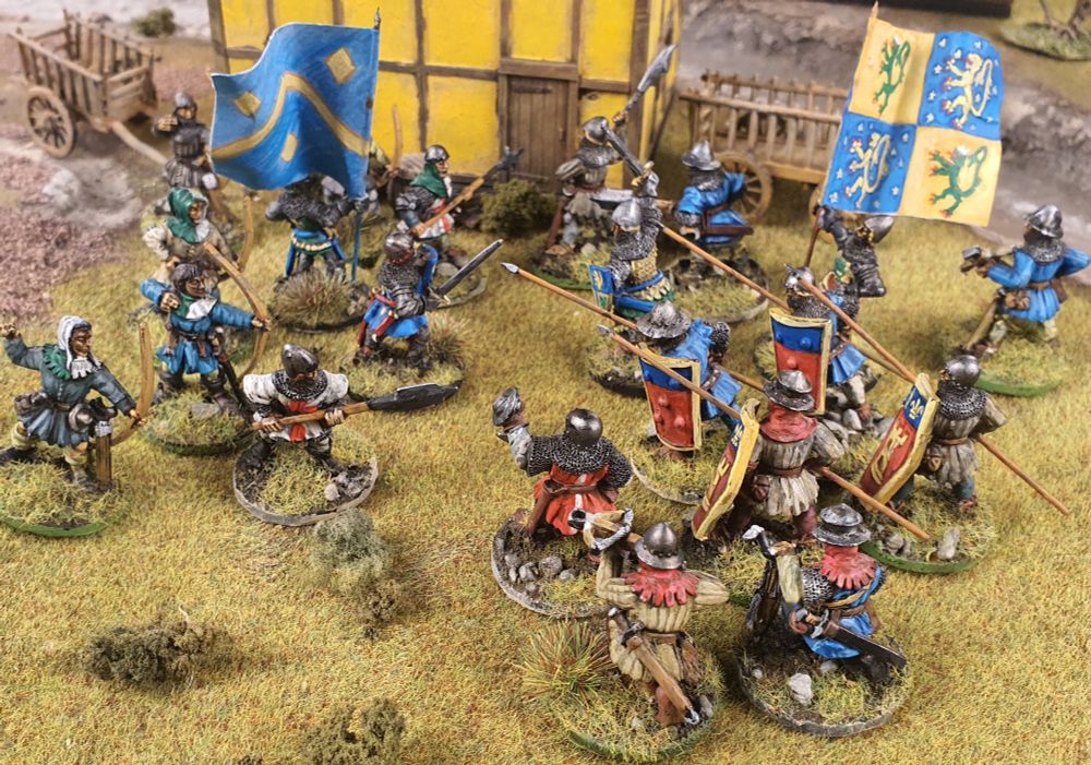 28mm Hundred Years War figures, set as if fighting in front of a timber-framed building.