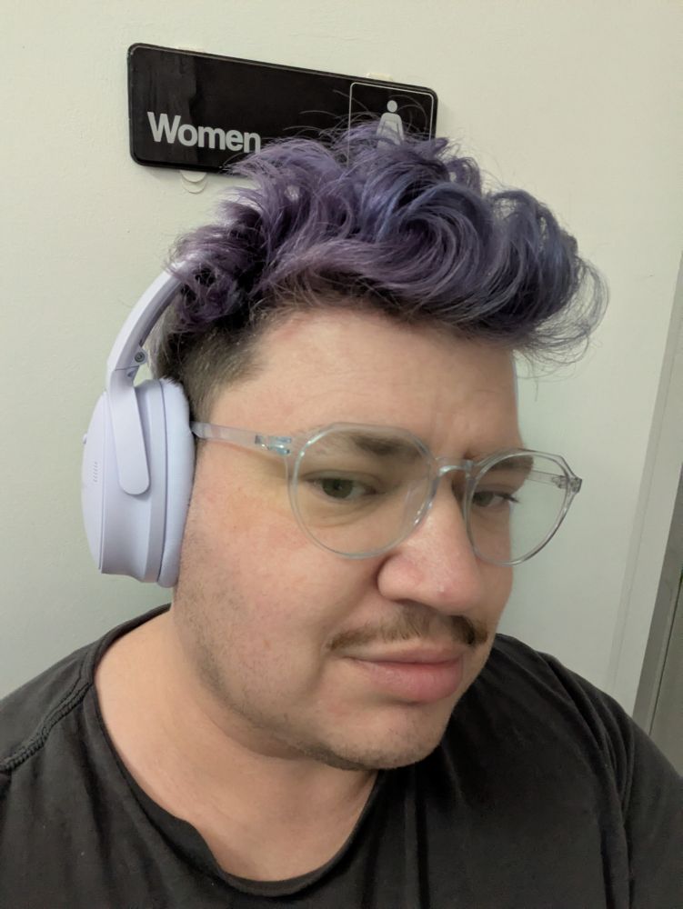 kirby selfie: lavender headphones, dusky purple blue ish mohawk 