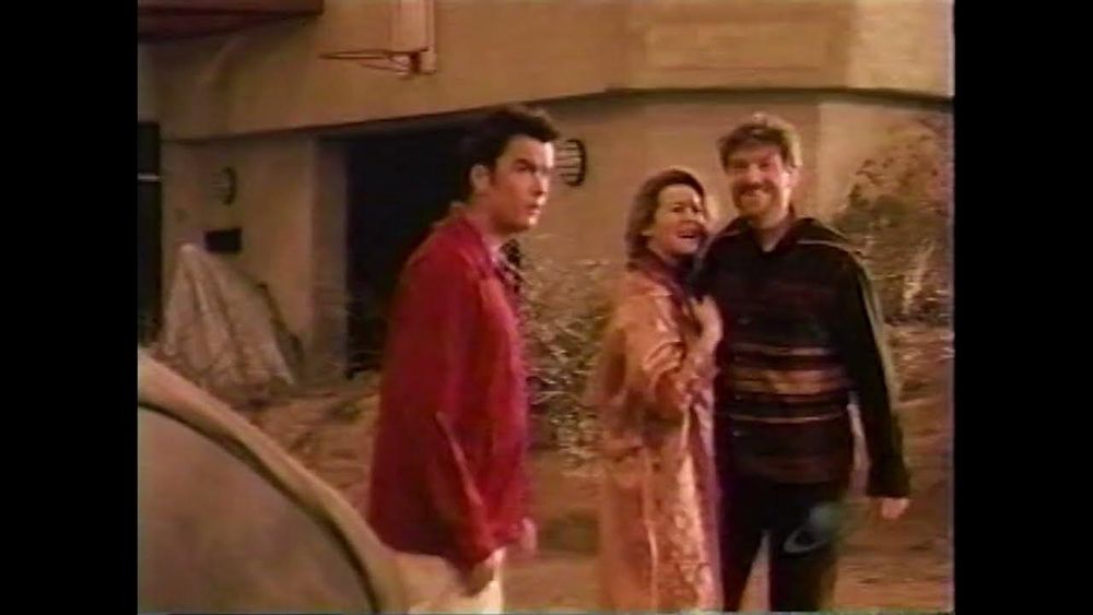 a low res image from Habitat of Balthazar Getty, Tchéky Karyo and Alice Krige outside of a house.