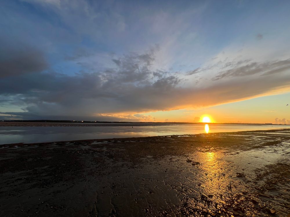 Sunset and clouds over the far out tide