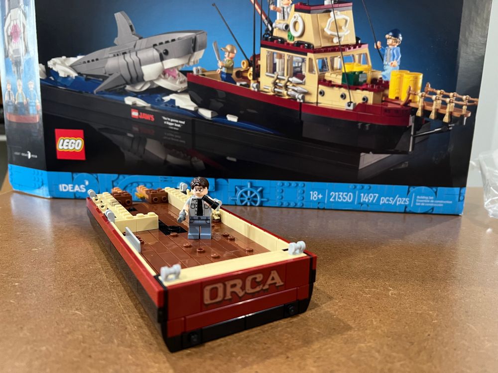 Photo of the Jaws Lego set- two bags complete. The boat, the Orca, is beginning to take shape and the Chief Brody mini fig makes it’s debut