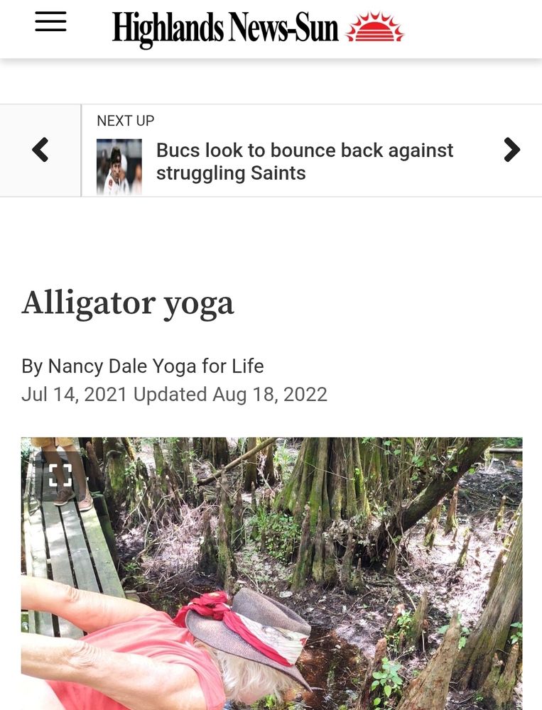 online page from the Highlands News-Sun, a Florida newspaper. it shows a senior femme bent down, arms stretched out behind, as she enters a pose in front of an otherwise unbothered alligator nearby.  The header reads 'Alligator Yoga'.