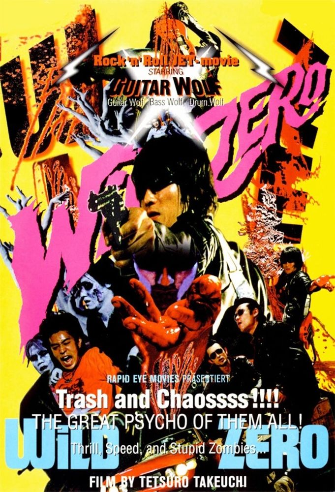 The poster for Wild Zero, the Guitar Wolf SF trash film. On a yellow background, the title is in pink in crazy uneven lettering, with the band in the foreground surrounded by figures and elements from the film- zombies, aliens etcetera. The text above the title ( which is in baby blue ) is " Trash and Chaos!!!! ".