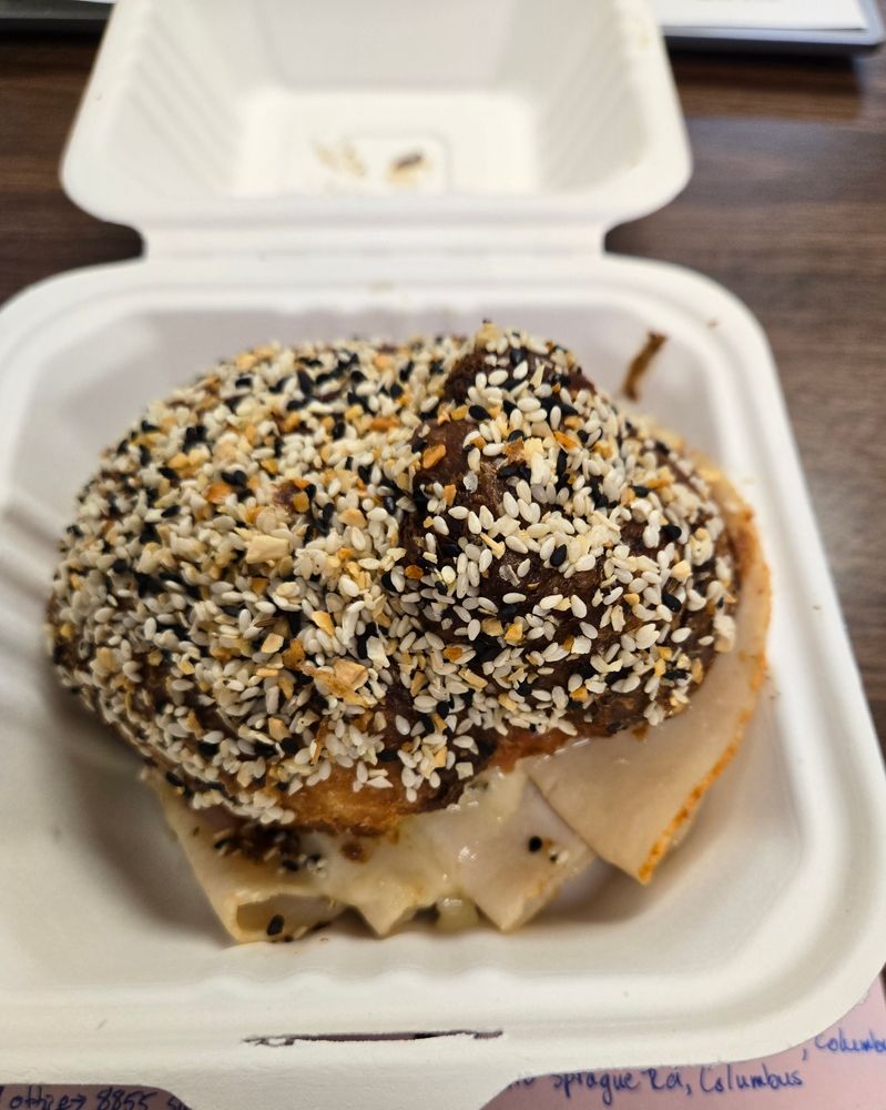 Sandwich in a white paper container. It is sliced turkey and Swiss and some other stuff I forget on an everything Volant. What's a volant? I don't exactly know either. 