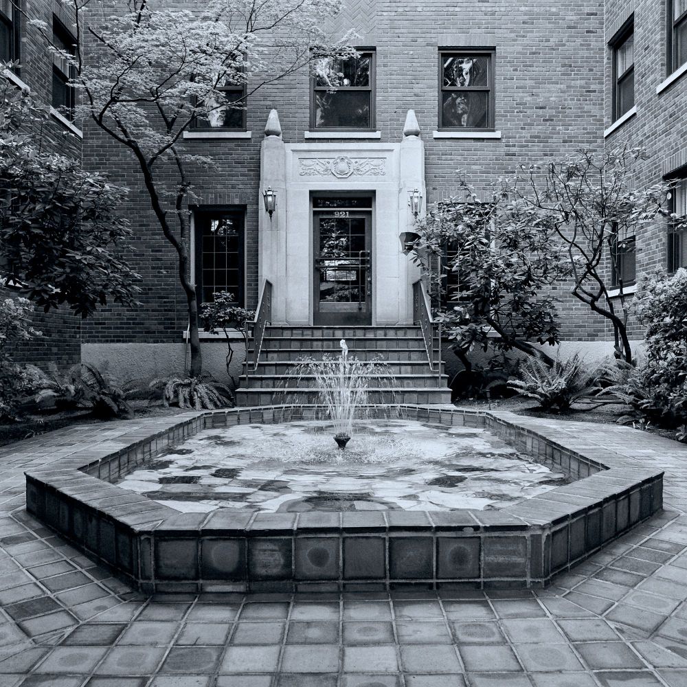 The courtyard of the beautifully maintained Glen Eden Apartments on Queen Anne hill in Seattle. I walked by it several times a week during the 10 years I lived on Queen Anne hill. Taken on Kodak Tri-X 400 film with the Zeiss CF 50mm F/4 lens on a Hasselblad 500C/M body. Copyright 2013 Allan Armstrong.