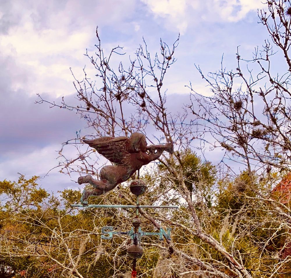 A very ‘weathered’ weather vane topped with an Angel blowing his trumpet to the north.
