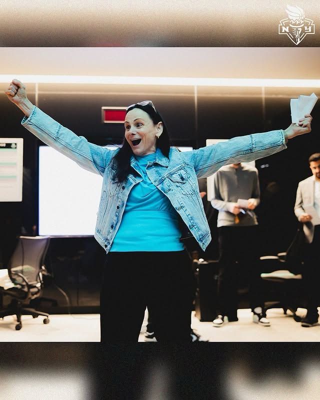 Sandy Brondello pumping her fists in the Liberty locker room