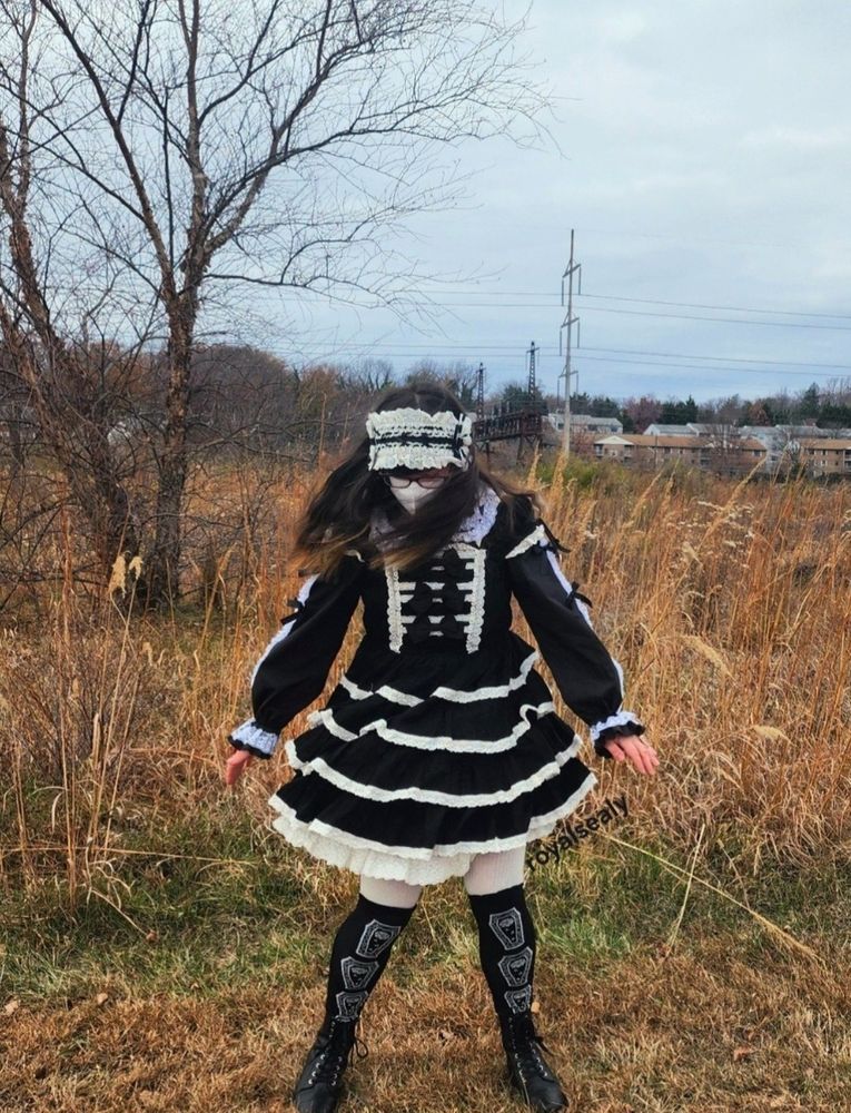 Another shot of Royalsealy swishing the skirt of his dress. In this one he is turned toward the camera, his face still pointing down and arms stretched out and down for balance.