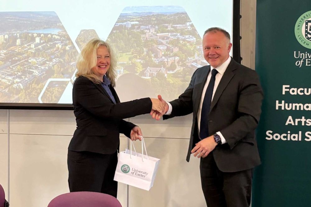 IMAGE - SFU FASS Dean Laurel Weldon shakes hands with Gareth Stansfield OBE, the Pro-Vice-Chancellor and Executive Dean of the University of Exeter's Faculty of Humanities, Arts and Social Sciences. 