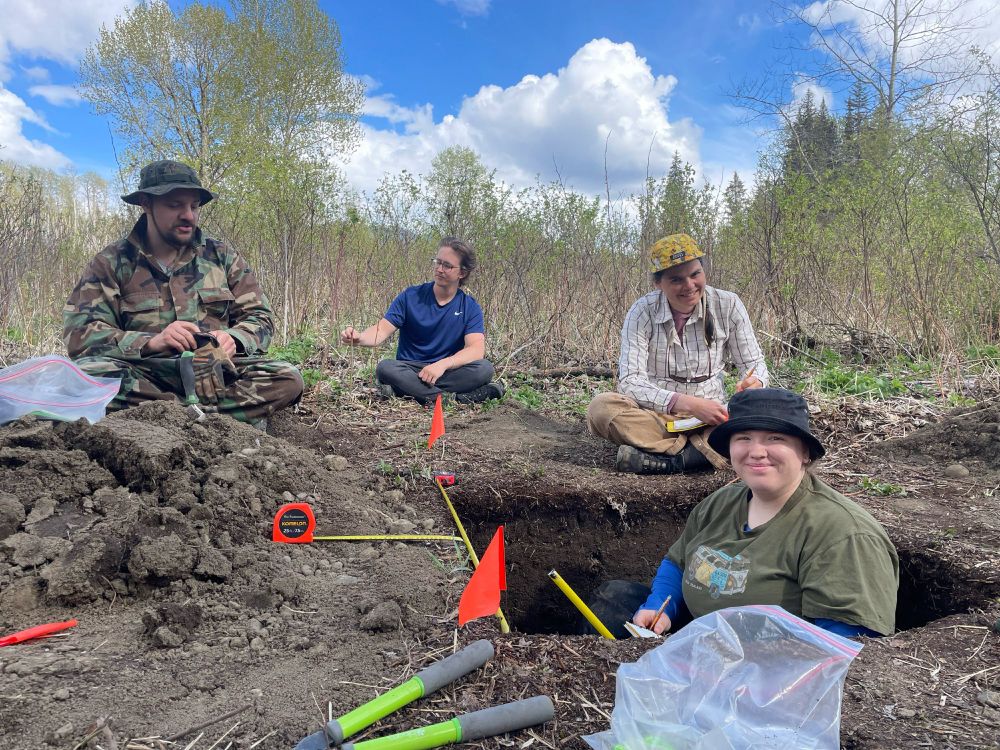 Students of the course in the field analyzing soil samples. 