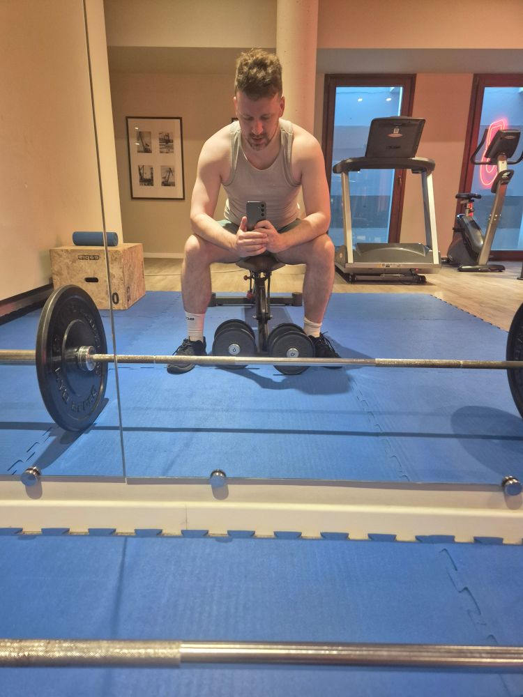 Man in small gym with very limited weights