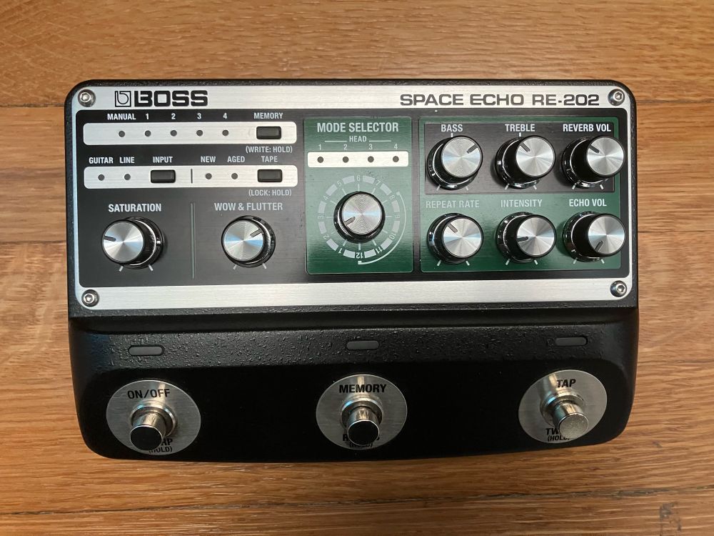 Roland Space Echo guitar pedal on a wood floor.