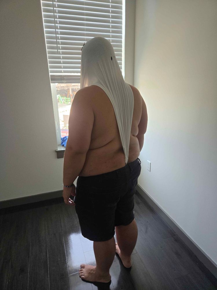 Me facing away from the camera wearing black jean shorts and a pair of oversized tighty whities that have been yanked into an atomic wedgie