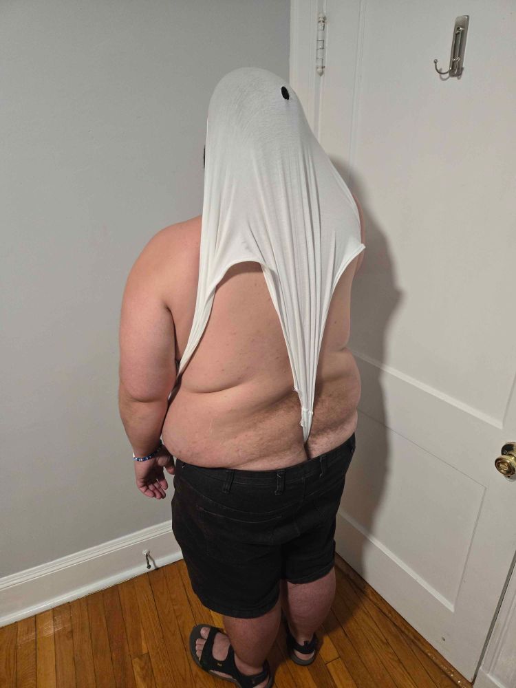 Me facing away from the camera wearing black jean shorts and a pair of oversized tighty whities that have been yanked into an atomic wedgie