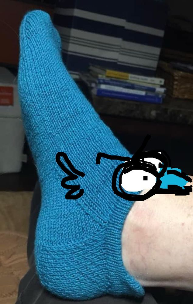 Blue creature with mouth wide open. 