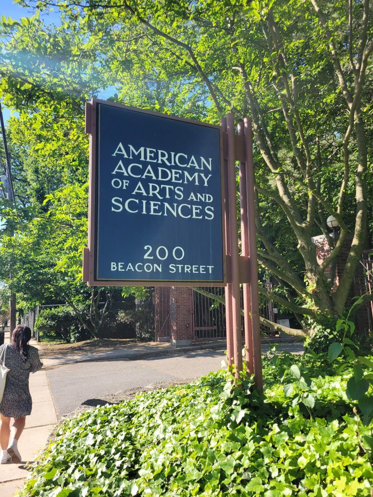 A sign in some greenery that reads "American Academy of Arts and Sciences. 200 Beacon Street"