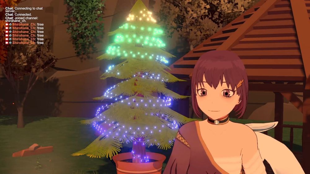 The interactive Christmas tree prop loaded into vNyan. The tree is lit up with blue green and white lights.