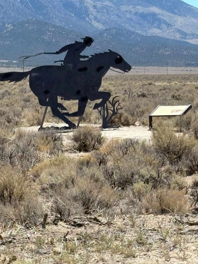 Metal sculpture of a pony express rider 
