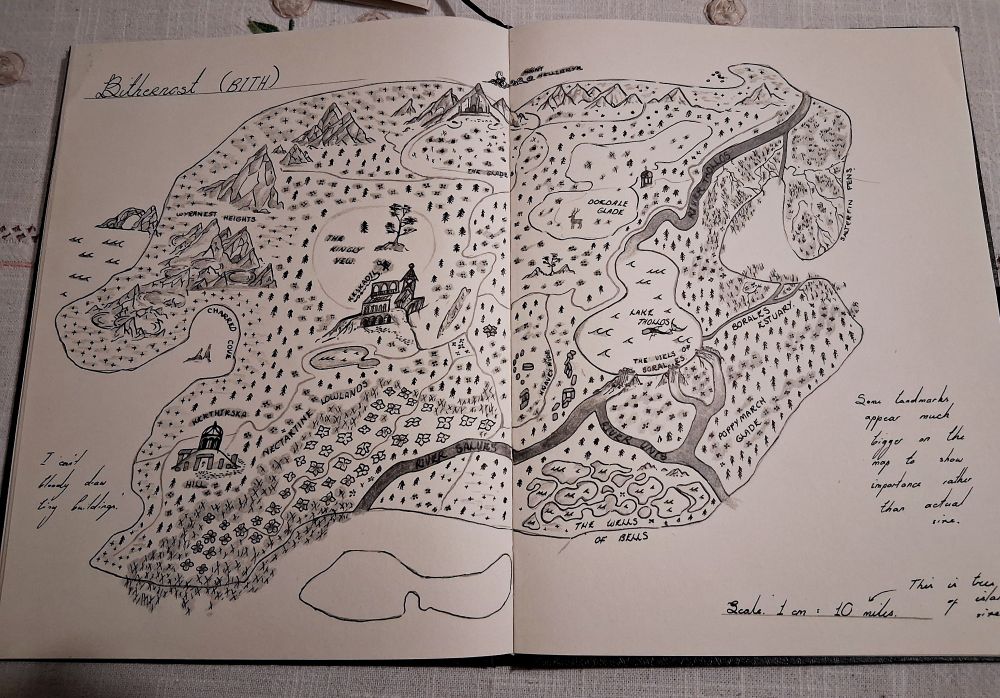 A fantasy map of a single island, complete with mountain ranges, ruins, black sand beaches and mountainous swamps, fens and cold rivers.
