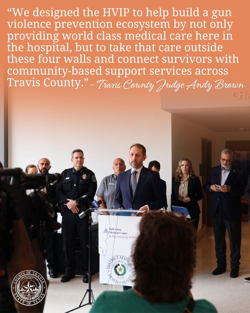 Photo of Judge Brown speaking at the press conference. Orange gradient on top of the photo with white text that reads "We designed the HVIP to help build a gun violence prevention ecosystem by not only providing world class medical care here in the hospital, but to take that care outside these four walls and connect survivors with community-based support services across Travis County.”
