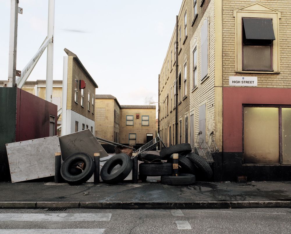 A barricade of tyres in a mocked-up street.