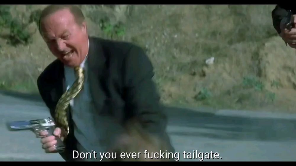 still frame of mr eddy from lost highway beating that motorist up with his gun for tailgating, red-faced and screaming. 